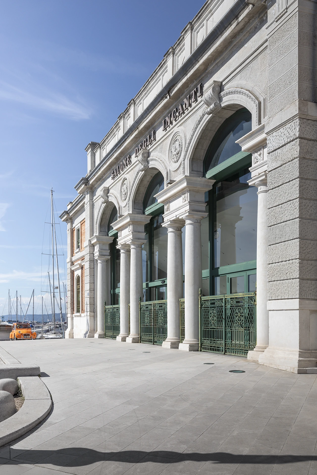 Salone degli Incanti a Trieste, storico edificio sul waterfront con facciata monumentale ad archi e colonne affacciata sul porto
